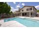 Backyard pool with surrounding stone patio and covered porch adjacent to the two-story home at 24709 N 75Th Way, Scottsdale, AZ 85255