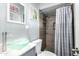 Bathroom with green glass vessel sink, tiled shower with curtain, and modern fixtures at 25615 S Lemon Ave, Queen Creek, AZ 85142