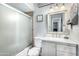 Cozy bathroom offers a vanity, framed mirror, and a tiled shower with glass door at 25615 S Lemon Ave, Queen Creek, AZ 85142