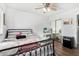 Comfortable bedroom with wood-look floors, ceiling fan, and large closet with mirrored doors at 25615 S Lemon Ave, Queen Creek, AZ 85142
