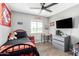 Comfortable bedroom with ceiling fan, window views, and a functional desk area at 25615 S Lemon Ave, Queen Creek, AZ 85142