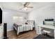 Cozy bedroom features wood-look floors, accent wall, a ceiling fan, and a vanity at 25615 S Lemon Ave, Queen Creek, AZ 85142