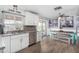 Bright eat-in kitchen featuring white cabinets, stainless appliances, and adjacent dining area with pool view at 25615 S Lemon Ave, Queen Creek, AZ 85142