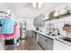 Functional laundry room features gray cabinets, white tile backsplash, and modern appliances at 25615 S Lemon Ave, Queen Creek, AZ 85142