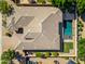 Stunning aerial view of the property showing the pool, lush landscaping, and beautiful roof at 2565 N 141St Ln, Goodyear, AZ 85395