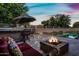 Inviting outdoor kitchen, swimming pool and landscape. The perfect retreat after a long day at 2565 N 141St Ln, Goodyear, AZ 85395