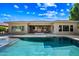 Relaxing backyard featuring a refreshing pool, covered patio, and beautiful landscaping at 2565 N 141St Ln, Goodyear, AZ 85395