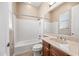 Bright bathroom with vanity and shower-tub combo, complemented by neutral finishes, offering a clean aesthetic at 2565 N 141St Ln, Goodyear, AZ 85395