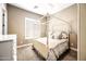 Cozy bedroom with a four-poster bed, plush carpet, and shuttered windows, perfect for relaxation and comfort at 2565 N 141St Ln, Goodyear, AZ 85395