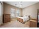 Calm bedroom with a classic wooden bed, dresser, and two end tables, paired with shuttered windows for natural light at 2565 N 141St Ln, Goodyear, AZ 85395