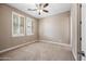 Neutral bedroom with carpet, shuttered windows, and ceiling fan providing plenty of natural light and comfort at 2565 N 141St Ln, Goodyear, AZ 85395