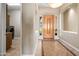 Inviting entryway features neutral walls, tile flooring, and a light wood front door at 2565 N 141St Ln, Goodyear, AZ 85395
