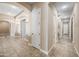 Inviting hallway with arched entryways and tiled floors, providing a seamless transition between living spaces at 2565 N 141St Ln, Goodyear, AZ 85395