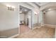 Open hallway with decorative lighting, tile floors, and an arched entrance to adjacent rooms at 2565 N 141St Ln, Goodyear, AZ 85395
