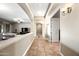 Bright hallway with tiled flooring and arched doorways leading to other rooms at 2565 N 141St Ln, Goodyear, AZ 85395