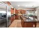 Spacious kitchen featuring stainless steel appliances, granite countertops, custom cabinets, and tile backsplash at 2565 N 141St Ln, Goodyear, AZ 85395