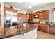 Kitchen featuring a stainless steel refrigerator, granite countertops, custom cabinets, and tile backsplash at 2565 N 141St Ln, Goodyear, AZ 85395