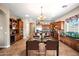 Open concept kitchen with an island and stainless steel appliances featuring an adjacent dining area at 2565 N 141St Ln, Goodyear, AZ 85395