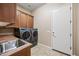 Convenient laundry room with modern washer and dryer, plus sink at 2565 N 141St Ln, Goodyear, AZ 85395