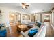 Spacious living room features an open floor plan, arched doorways, and stylish wood flooring for comfortable living at 2565 N 141St Ln, Goodyear, AZ 85395