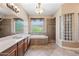 Well-lit main bathroom with soaking tub, walk-in shower, and private commode area at 2565 N 141St Ln, Goodyear, AZ 85395