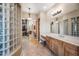 Main bathroom featuring dual sinks, a makeup vanity, and access to a walk-in closet at 2565 N 141St Ln, Goodyear, AZ 85395