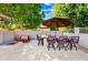Outdoor patio area with a dining table and fire pit offers an inviting space at 2565 N 141St Ln, Goodyear, AZ 85395