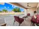 Covered patio with comfortable seating, ceiling fan, and a view of the pool and backyard at 2565 N 141St Ln, Goodyear, AZ 85395