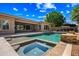 Gorgeous pool and spa with lush landscaping creating a backyard oasis for relaxation at 2565 N 141St Ln, Goodyear, AZ 85395