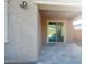A covered back patio with neutral-colored pavers and a sliding glass door to the home's interior at 2727 N Acacia Way, Buckeye, AZ 85396