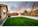 Serene backyard oasis featuring lush green lawn and privacy fence at 2727 N Acacia Way, Buckeye, AZ 85396