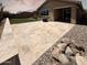 Spacious backyard featuring decorative rocks, desert landscaping, and light stone patio tiles at 2727 N Acacia Way, Buckeye, AZ 85396