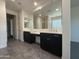 Bright bathroom offers dual sinks, a large mirror, and a walk-in shower for spa-like experience at 2727 N Acacia Way, Buckeye, AZ 85396