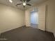 Spacious bedroom with a ceiling fan and adjoining room, perfect for relaxing or entertaining at 2727 N Acacia Way, Buckeye, AZ 85396