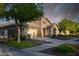 Charming single-Gathering home featuring a stone facade, two-car garage, and meticulously manicured landscaping at 2727 N Acacia Way, Buckeye, AZ 85396