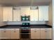 Modern kitchen featuring stainless steel oven and microwave appliances and white cabinetry at 2727 N Acacia Way, Buckeye, AZ 85396