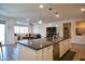 Open concept kitchen with island and pendant lighting at 2727 N Acacia Way, Buckeye, AZ 85396