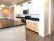 Bright kitchen with stainless steel appliances, granite countertops, and a kitchen island at 2727 N Acacia Way, Buckeye, AZ 85396