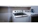 Well-equipped laundry room with modern, front-loading washer and dryer at 2727 N Acacia Way, Buckeye, AZ 85396