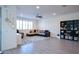Spacious living room with large windows, a ceiling fan, a comfortable sectional sofa, and stylish decor at 2727 N Acacia Way, Buckeye, AZ 85396