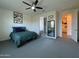 Bedroom featuring a ceiling fan, neutral paint, and ensuite bathroom for added comfort and convenience at 2727 N Acacia Way, Buckeye, AZ 85396