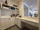 Bright office space with white cabinets, open shelving, and a built-in desk perfect for working from home at 2727 N Acacia Way, Buckeye, AZ 85396