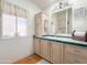 Cozy bathroom with wood cabinets, a vanity, a mirror, and a window at 3104 E Broadway Rd # 212, Mesa, AZ 85204