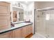 Well-lit bathroom featuring a vanity with sink, mirrored cabinet, and a glass-enclosed shower at 3104 E Broadway Rd # 212, Mesa, AZ 85204