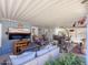 Relaxing covered patio with a comfortable seating area, TV, and decorative accents at 3104 E Broadway Rd # 212, Mesa, AZ 85204