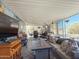 Relaxing covered patio with a comfortable seating area, TV, and decorative accents at 3104 E Broadway Rd # 212, Mesa, AZ 85204