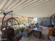Relaxing covered patio with a comfortable seating area, TV, and decorative accents at 3104 E Broadway Rd # 212, Mesa, AZ 85204
