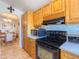 Cozy kitchen with wood cabinets, modern appliances, and an adjacent dining area at 3104 E Broadway Rd # 212, Mesa, AZ 85204