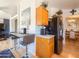 Efficient kitchen area with breakfast bar, wood cabinets, and modern appliances at 3104 E Broadway Rd # 212, Mesa, AZ 85204