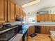 Charming kitchen with wood cabinets, modern appliances, and ample counter space at 3104 E Broadway Rd # 212, Mesa, AZ 85204